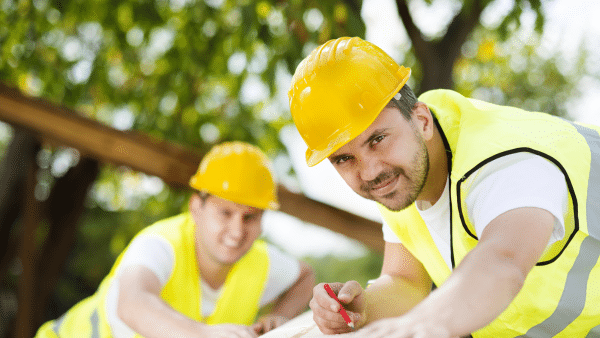 a group of men wearing yellow hard hats